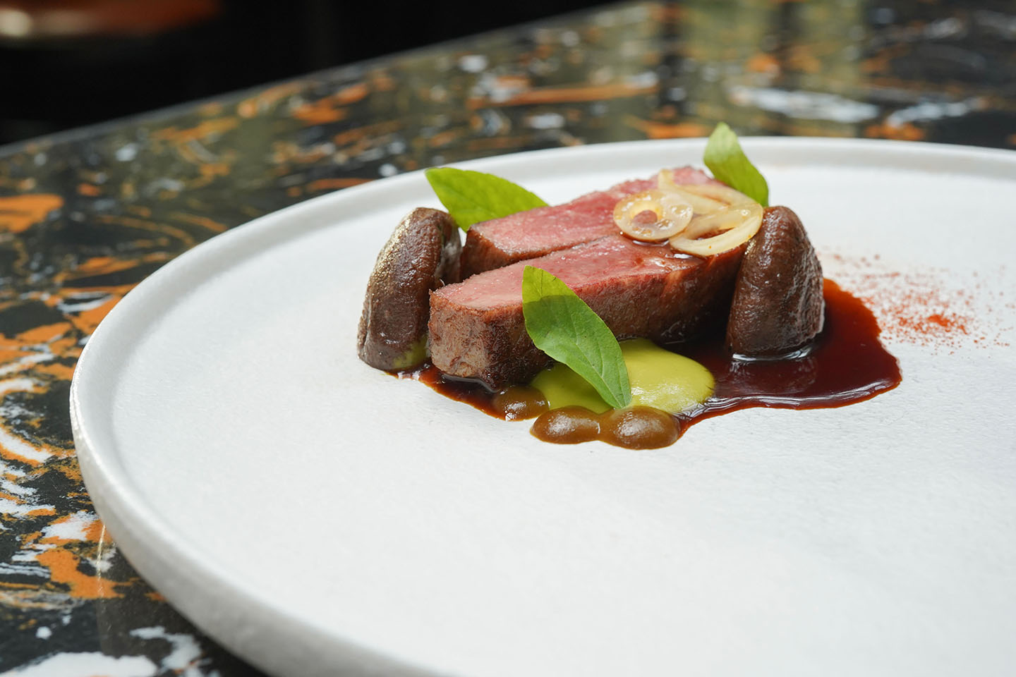 Australian Wagyu striploin with grilled shitake mushroom, garlicshoot and tamarind sauce