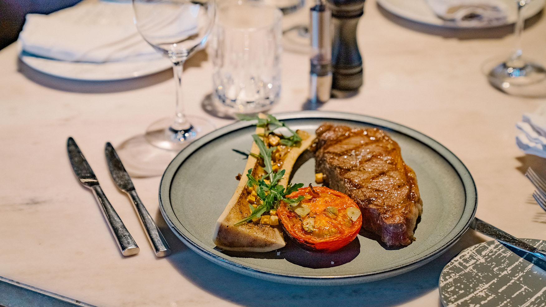 Grilled beef rib eyes with bone marrow and tomato Black Angus beef, MB2+